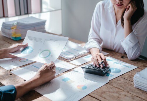 women with a calculator at desk